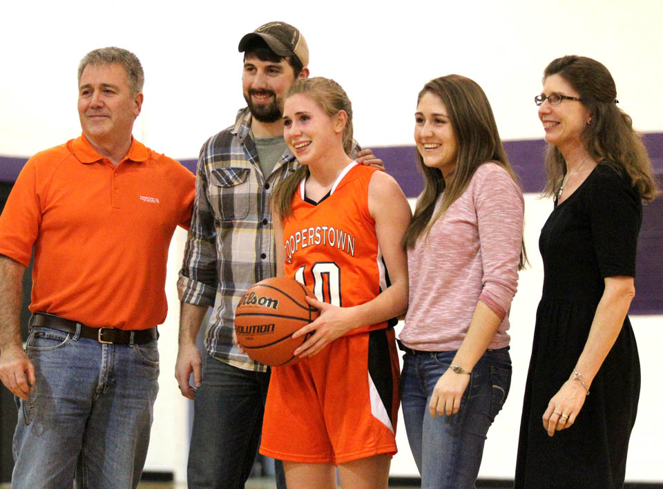 Cooperstown senior guard Liz Millea was joined on the court by her family following her record breaking shot in Milford Tuesday. Millea scored a season high 34 points, and broke Samantha Fox's school career scoring record. The Hawkeyes defeated the Wildcats 50-35 in the non-league game. (Cheryl Clough/AllOTSEGO.com)