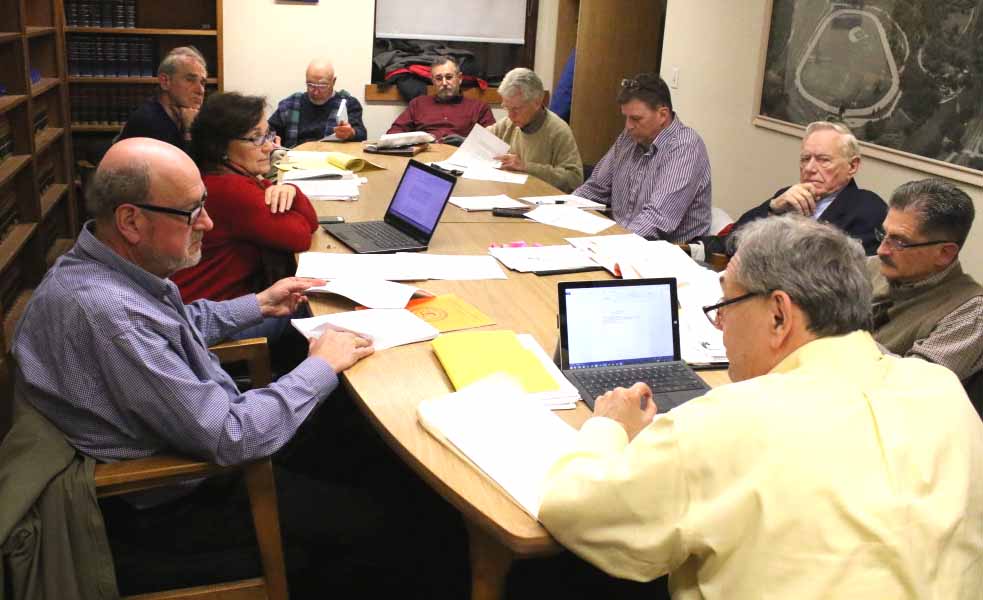 The original Charter Commission has been advised that emergency powers must be exercised by a city manager, but City Attorney David Merzig, left, said Municipal Home Rule Law would allow a city to give those powers to the mayor. Clockwise from Merzig, others at tonight's ad hoc Charter Revision Committee were committee member Melissa Nicosia; citizen George Siaros; former Charter Commission members Paul Scheele and Steve Londner; Council member John Rafter; committee members Russ Southard, David W. Brenner and David Martindale, and committee chair John Nader. (Ian Austin/AllOTSEGO.com)