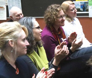 Among the Hartwick faculty recognized for their work in making the center reality were Carly Ficano (green top) and Mary Allen (purple top). Applauding at left is Otsego Chamber President Barbara Ann Heegan.