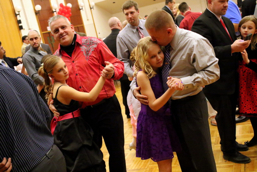 Shane Couse and daughter Shayanna, left, Oneonta, and Ron Coe with daughter Veronica, Oneonta, right, slow dance at the YMCA's annual Father Daughter Dance this evening, held at SUNY Oneonta's Hunt Union Ballroom. (Ian Austin/AllOTSEGO.com)
