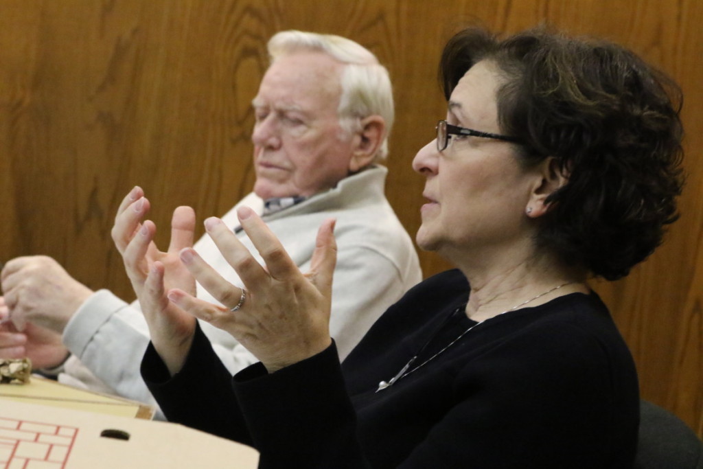 Council Member Melissa Nicosia, Second Ward, explains why she believes the qualifications for the City Manager should be removed from the charter. Former mayor David Brenner listens. (Ian Austin/AlOTSEGO.com)