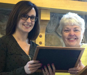 Felicia Weaver, left, receives Arc's Employee of 2015 Award from Executive Director Pat Knuth.
