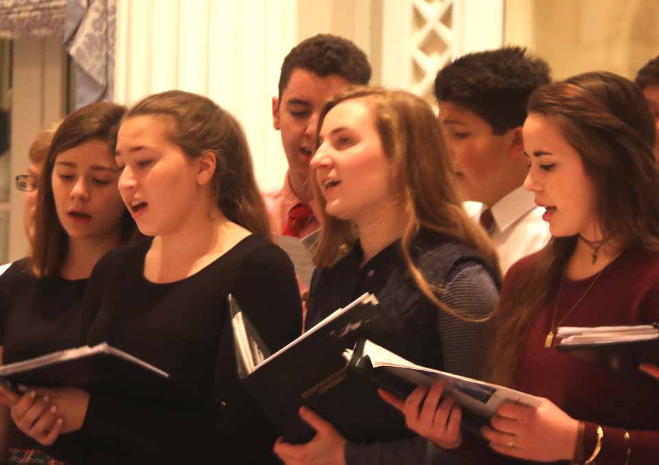CCS' Harmonia chorus, conducted by Sal Salvaggio, fills The Otesaga as the Friends of Music and Art's Cabaret Night launched weekend of Cooperstown Winter Carnival events this evening. Front row, from left, are Josie Hovis, Lauren Lionetti, Alexandra Russo and Maria Noto. Back row are Anthony Birch, left, and William Freidman. (Jim Kevlin/AllOTSEGO.com)