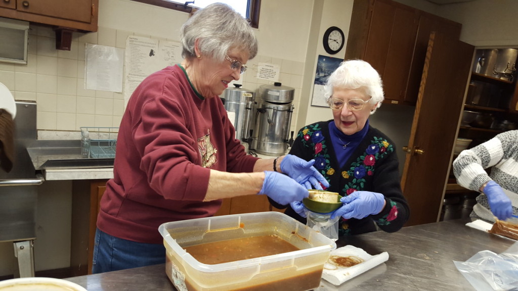 Barbara Fritz and Eleanor Rutherford prepare hearty helpings of turkey chili to give away as part of the Elm Park Methodist Church's "Soup To Go" program. From 4-5 p.m. every Wednesday until March 9, you can pick up free, homemade soup to take home. (Ian Austin/AllOTSEGO.com) 
