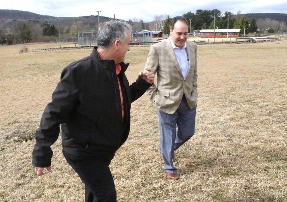 Jeff Hyman, right, of Hyman Hemispheric, the prospective development of a waterpark, walks the Cooperstown Fun Park property with its current owner, Bob Hickey. (Jim Kevlin/AllOTSEGO.com)