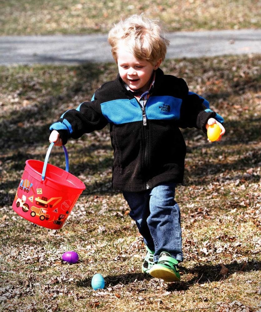 2-year old Hudson Cox runs towards his parents after finding a yellow egg during the 4th annual Easter Egg Hunt held in  Milford's Wilber Park on Sunday. (Cheryl Clough/AllOTSEGO.com)