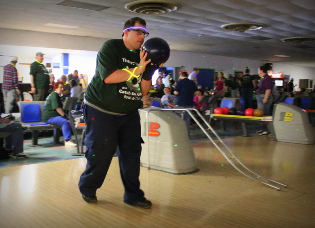 James Straney, Oneonta, sets up his throw at the 2nd annual Catch The Glow Bowl-a-thon at Holiday Lanes this afternoon. The event, Hosted by The ARC Otsego, had 17 teams who raised money for the Helping Hands Fund, which helps to cover unexpected costs by those receiving ARC Otsego services. Lanes were sponsored by local businesses and individuals. Glow necklaces, door prizes and silent auction kept the place buzzing til close. (Ian Austin/AllOTSEGO.com)