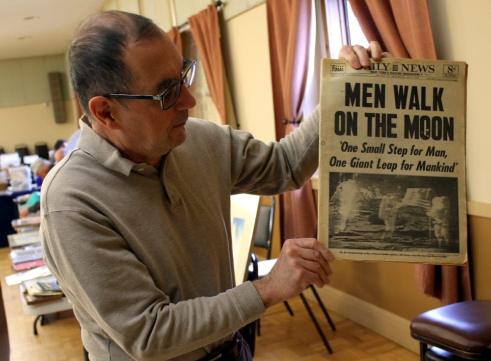 Treasures from the past were plentiful at the Greater Oneonta's 12th annual Postcard and Ephemera held at the Elk's Club in Oneonta on Saturday afternoon. Here, GOHS board member and co-chair of the show Bill Pietraface holds up a historic issue of the Daily News commemorating the moon landing. (Ian Austin/AllOTSEGO.com)