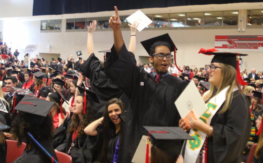 Obed Done, Bronx, leads the crowd in cheers at this morning's SUNY Oneonta graduation. To his left is his friend Hailey Mancini, Bay Shore. (Ian Austin/AllOTSEGO.com)