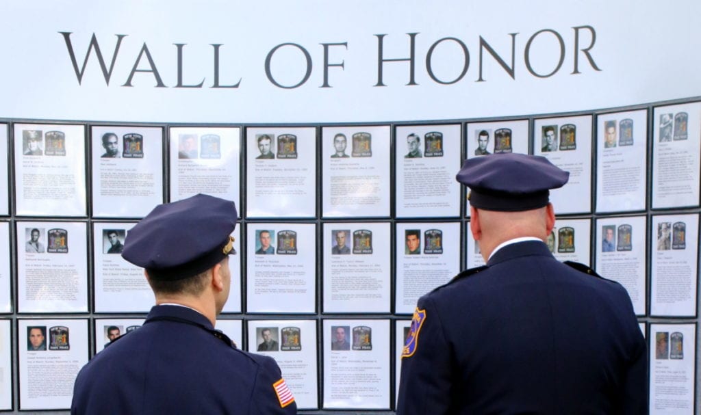 Oneonta Police Chief Dennis Nayor and Lieutenant Doug Brenner pause to pay respects to fallen officers at the New York State Police Troop C Memorial Day service this morning in Sidney. (Ian Austin/AllOTSEGO.com)