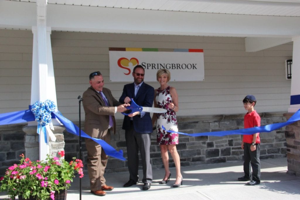Springbrook Board member Dr. Gerald Pondolfino, Springbrook Parent and Donor Meyer Safdieh, and Springbrook CEO Patricia Kennedy cut the ribbon officially opening the newest home at Springbrook. (Photo Credit: Kira Delanoy)