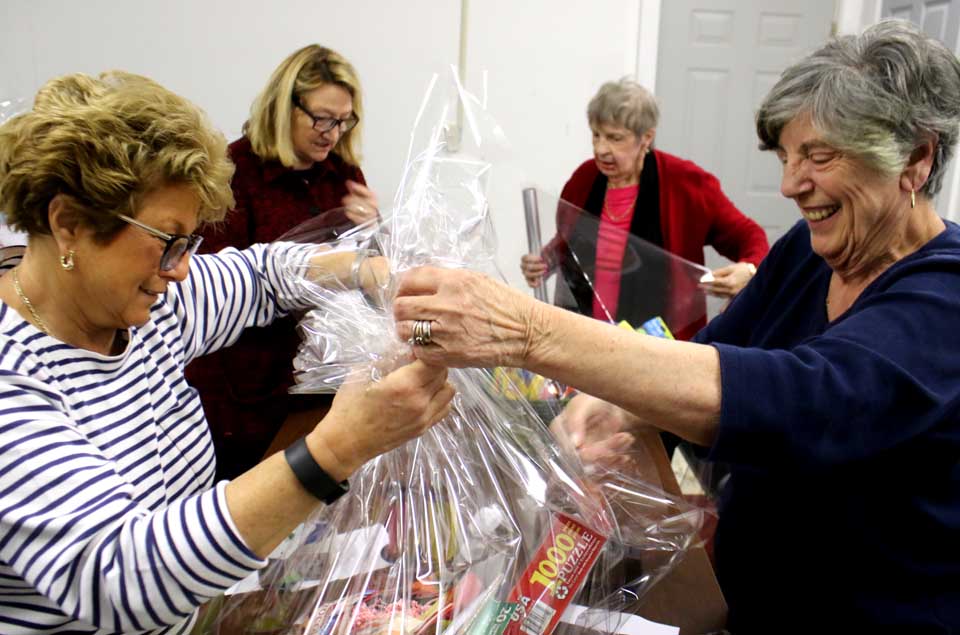 Cooperstown Rotarians – from left, Marge Landers, Margaret Savoie, Karen Cadwalader and Joan Badgley – pack one of 65 baskets of goodies that will be auctioned off at 5 p.m. Friday at 1 Railroad Ave., Cooperstown, a “warm-up” to Saturday’s “Spring Fling.” Gary Kuch and Bob Schlather will be auctioneers. Food and refreshments available. The auction is a preview to Saturday’s main in event – from noon to 5 p.m., a festival of music, food, games and other fun in the middle of Railroad Avenue. Highlights include the Spurbeck’s Market 75th anniversary, and samples provided by the Beverage Trail. (Jim Kevlin/AllOTSEGO.com)