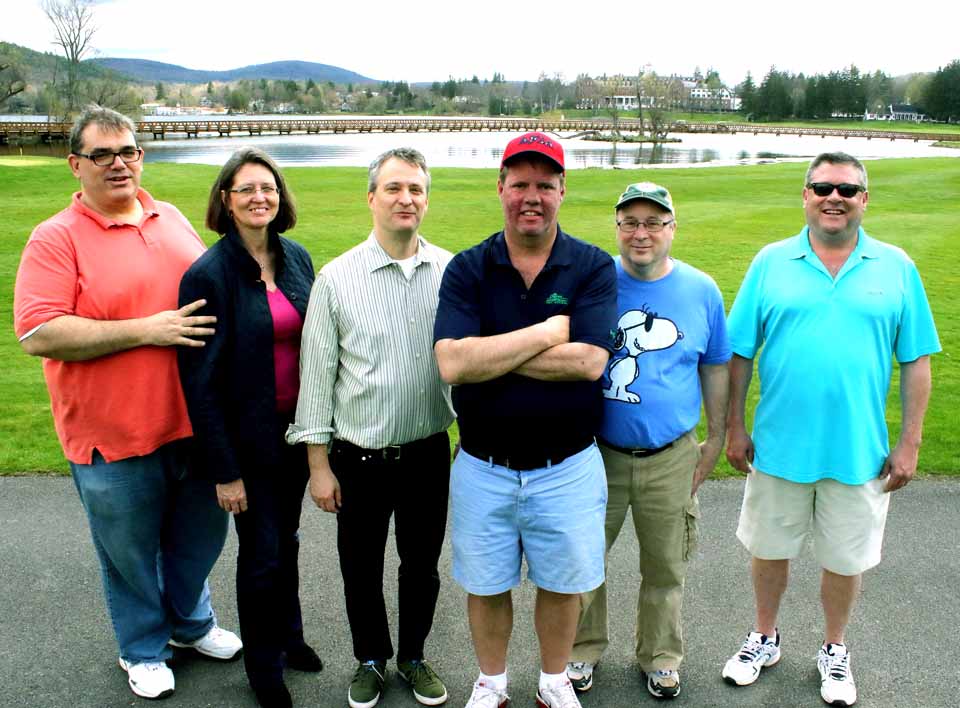 Dad Mike Trosset's pals from his Georgetown days are in Cooperstown this weekend to cheer on Mike's son Ted, one of the county's foremost young golfers, who is playing in the New York State Junior PGA Tournament this weekend at The Otesaga's Leatherstocking Golf Course. The Junior PGA, played at Leatherstocking for the past 11 years, continues through Sunday afternoon. From left are Jim Frohnhofer and his wife, Keri Dooley, Derek Sherman, the host, Bob Ennis and John Doyle. (Jim Kevlin/AllOTSEGO.com)