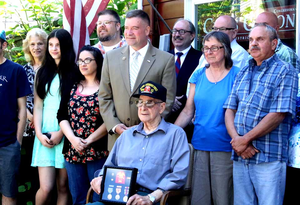 U.S. Rep. Chris Gibson, R-19, poses with World War II veteran Donald Diamond, Central Bridge, a few moments after presenting him with a boxed set of all the medals the sailor earned during his service, which included the D-Day invasion. Diamond, now 90, enlisted when he was 17, and participated in the Normandy invasion when he was 18. Diamond, a coxswain, never spoke of his war experiences until approached by a reporter at a parade in Schoharie County following Hurricane Irene. His niece, Kathy Fallon, contacted the congressman's office, who was able to obtained a European Theater Medal, two stars; an American Theatre Medal, a Asiatic-Pacific Medal, one star, and a Victory Medal for his constituent. One of Diamond's son traveled from Washington State for today's ceremony, held in Gibson's Cooperstown office. (Jim Kevlin/AllOTSEGO.com)