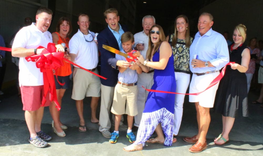 George Allen, Melissa Miosek, Ryan Birdsall, Louis B. Hager III, Whit Hager, Matt Curley, Alicia Hager, Kathleen Emmett, Louis B. Hager, Jr., and Barbara Ann Heegan cut the ceremonial ribbon that marks the New Northern Eagle Beverage Plant on Brown. St. in Oneonta, officially open. Festivities filled the afternoon highlighted by tours, tastings, Brooks BBQ and music by The Round House Rockers. (Ian Austin/AllOTSEGO.com)