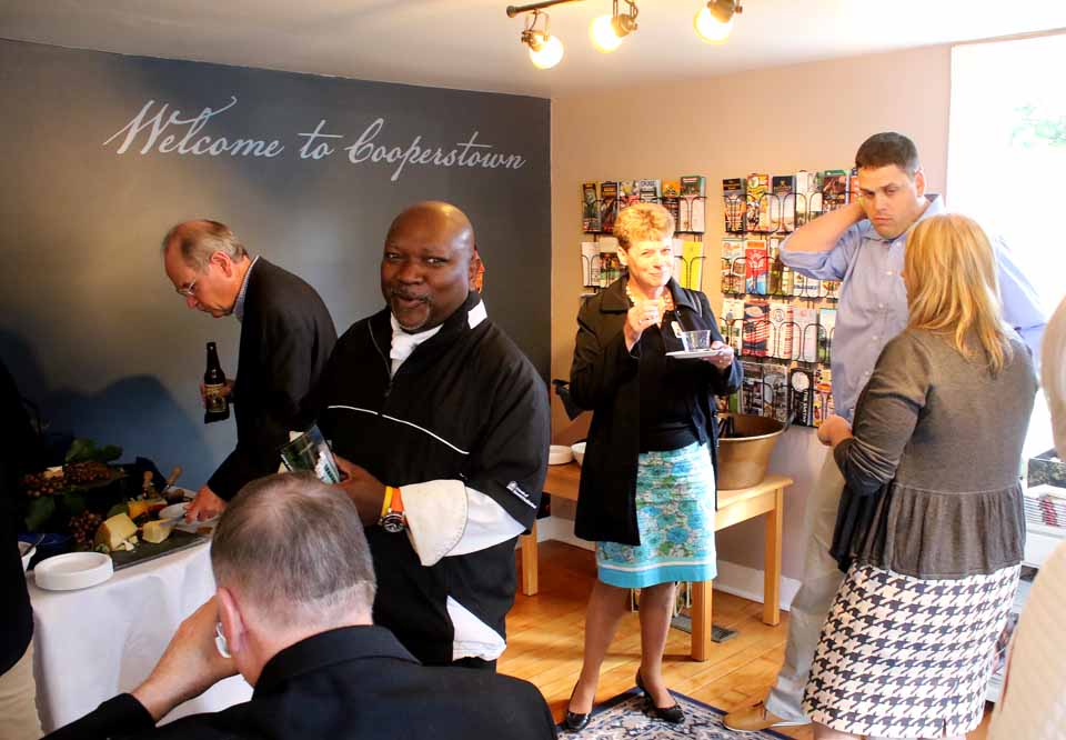 A hundred-some members of the Cooperstown Chamber of Commerce passed through the doors to examine renovations to the first floor during an open house at the historic Higgins Cottage at 31 Chestnut St. Among attendees were, from left, Jim Donley of Doubleday Drivers; Chef Michael Gregory of The Lake House; Colleen Donnelly, a Bassett recruiter, and Matt Hazzard, Chamber executive director. The renovations, directed by the chamber's Hannah Bergene, removed a tall counter and created a more open look, with chairs that allow visitors to sit and review publicity material. (Jim Kevlin/AllOTSEGO.com)