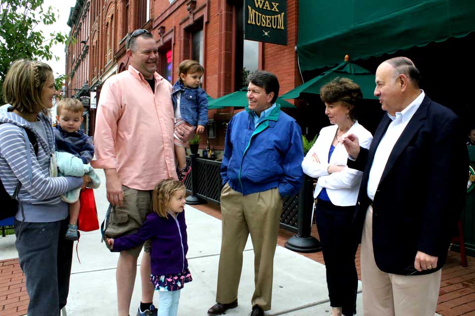 Republican John Faso, center, who is running to succeed U.S Rep. Chris Gibson in the 19th Congressional District, stops to chat with Reid Nagelschmidt and his family a few minutes ago while campaigning in downtown Coopestown. With him is wife Mary Frances and, at right, retired assemblyman Tony Casale. Casale endorsed Faso as "a true conservative who knows the value of a dollar." Faso will be in Richfield Springs this afternoon meeting with supporters there. The 19th district primary is Tuesday, June 28, and Faso, a former Assembly minority leader and gubernatorial candidate, will face Andrew Heaney, a businessman from Dutchess County. Zephyr Teachout and Will Yandik are competing for the Democratic nomination. (Jim Kevlin/AllOTSEGO.com)