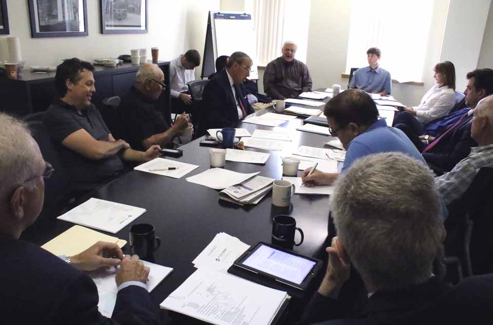 Otsego Now President Sandy Mathes, center, briefs his board this morning. From left are