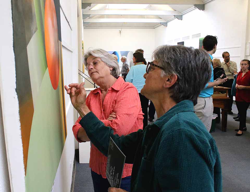 Friends of artist Richard Saba – Cynthia Wilson, Cobleskill, right, and Gail Sondergaard, Worcester – in "Recent Works," which opened this evening at the Cooperstown Art Association's Gallery A. In Gallery C, the Leatherstocking Brush & Palette Club's annual show also opened. (Jim Kevlin/AllOTSEGO.com)