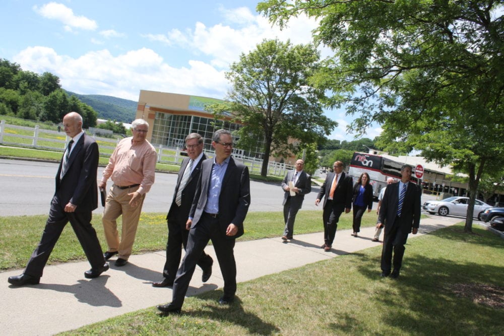 Mayor Gary Herzig and Sandy Mathis lead a tour of 'The New Downtown', area of Market Street slated for development thanks to the $10 million dollars the city received last week. On the tour was Senator Jim Seward, commissioner of homes and urban renewal James Reuben, president of the office of Community Renewal Chris Leo, program director for the economic development program Jason Purvis, Meg Hungerford, Jeff House and Jeff Bishop. (Ian Austin/AllOTSEGO.com)