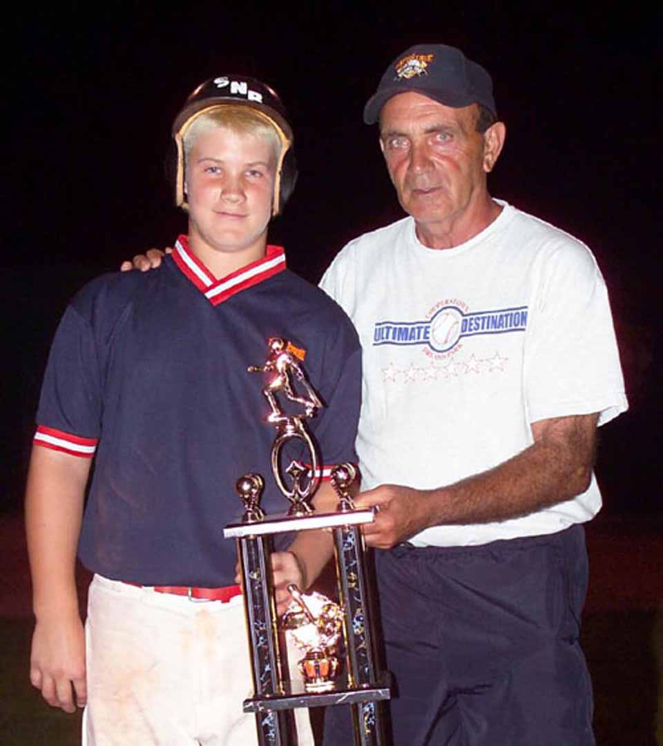 Bryce Harper receiving a trophy from Lou Presutti II after his week at Cooperstown Dreams Park.