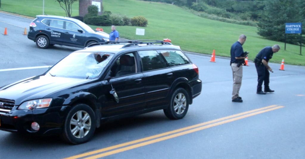 Detective Joe Tiemann and Sgt. Ralph Pajerski, right, of the OPD, examine the accident scene this evening. (Ian Austin/AllOTSEGO.com)