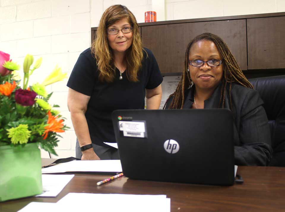 Her first day on the job, Donna Lucy, Cooperstown Central School's new middle and high school principal, pauses from conferring with her assistant, Alena Krug. Ms. Lucy has been founding principal of Evolutions High School in Providence, R.I. She succeeds Mike Cring, who joined the Arlington Central School District, near Poughkeepsie, as athletic director. (Jim Kevlin/AllOTSEGO.com)