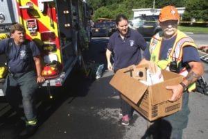 The EMS squad delivers coffee from Stagecoach to Glen Falk, right, the department's vice president, and Assistant Chief Mike Molloy.