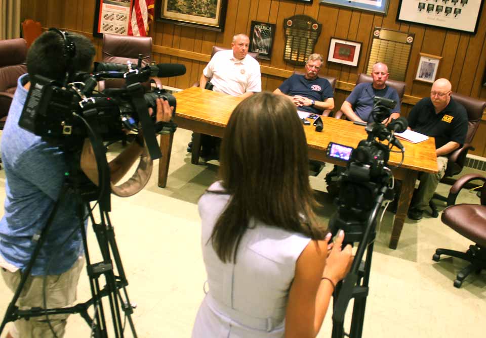 Cooperstown Police Chief Mike Covert, right, introduce those involved in fighting and investigating the Cooperstown Motel fire during a press briefing that began a few moments ago at the fire hall on Chestnut Street. Others, from left, are Investigator William McGovern from the state Fire Prevention & Control Officer; Cooperstown Fire Chief Jim Tallman and county Emergency Services Coordinator Kevin Ritton. (Jim Kevlin/AllOTSEGO.com)
