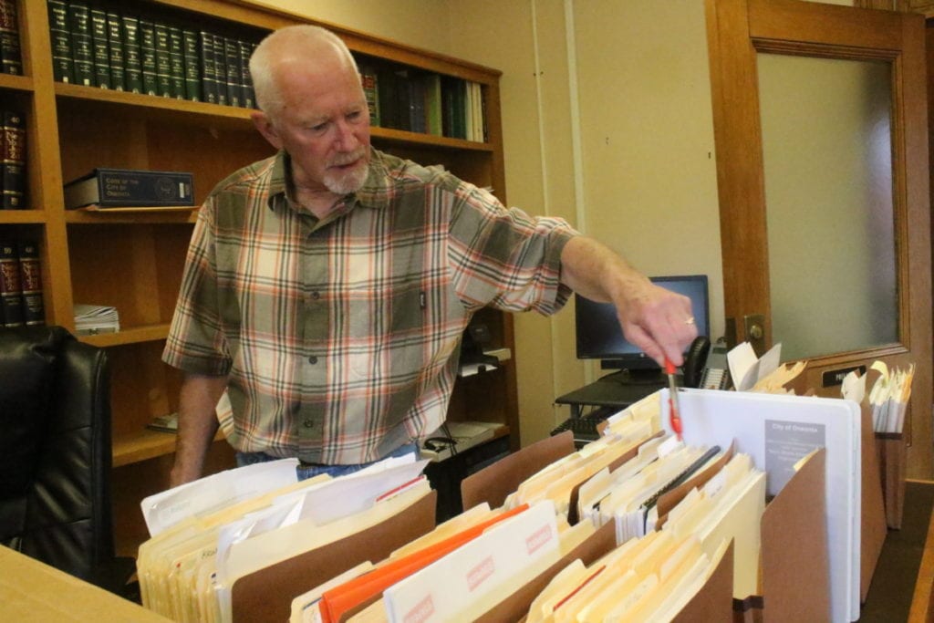 Retiring Housing Rehabilitation Specialist Jeff House looks over the files of grants he's worked on since joining City Hall full-time in 2008. Prior to that, he was a consultant for the city's downtown revitalization efforts for 12 years. (Ian Austin/AllOTSEGO.com)