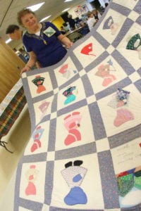 Barbara Blanchard shows off the Sunbonnet Sue quilt her class made for her. (Ian Austin/AllOTSEGO.com)