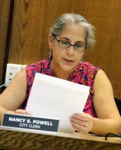 Nancy Powell, City Clerk, reads a letter from Karyl Sage pleading with the city not to destroy 27 Market Street.