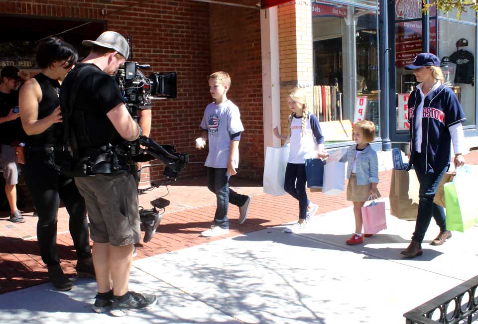 If you're in downtown Cooperstown over the next hour, you may see this crew from Opposable Thumbs, a San Diego based marketing agency, creating footage for a TV ad campaign planned by Mavis Discount Tire. Producer Jason Taragan said the spot is built around a family vacation and, "as a destination, Cooperstown's a great place for a family get-away." The spot begins with a dad, mom, son and daughter coming out of Cooperstown Bat Co. onto the Main Street sideway. This afternoon, the crew, which is based in New York City, planned to shoot additional footage at the Stokes Farm on Pink Street, Town of Middlefield. Taragan said Nancy Angerer of Cooperstown was the local contact in setting up the shoot; "she's been great," he said. (Jim Kevlin/AllOTSEGO.com)
