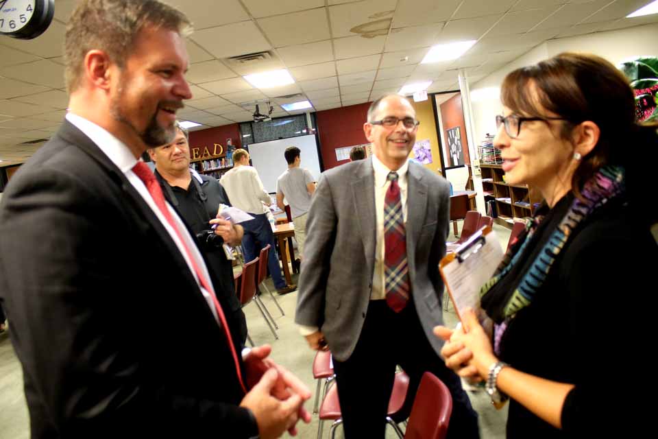 Dr. William Crankshaw, Cooperstown’s new superintendent of schools, is congratulated by Lisa Price, who used to work with him at Northville and has been at Cooperstown Central for the past five years. At center is the superintendent’s partner, Wally Hart. (Jim Kevlin/AllOTSEGO.com)
