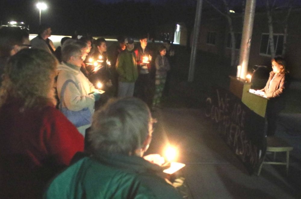 CCS student Natalie Schieber, reads a statement on behalf of classmate Josie Hovis at this evening Community Vigil at the flagpole in front of Cooperstown Central: ""We can't control who hurts us or who wins an election, but we can control how we react." Other speakers were Principal Donna Lucy, and Bobby Walker, a senior and founder of the Otsego County Young Republicans, who said to his fellow party members, "We won. Clebrate and joy is natural and expected. DO NOT confuse mockiery and insults with these ... Remember, it could have easily been the other way." In asking for a moment of silence, Lucy said "the intentions are peace, unity, comfort adn hope for our community and our nation." (Jim Kevlin/AllOTSEGO.com_