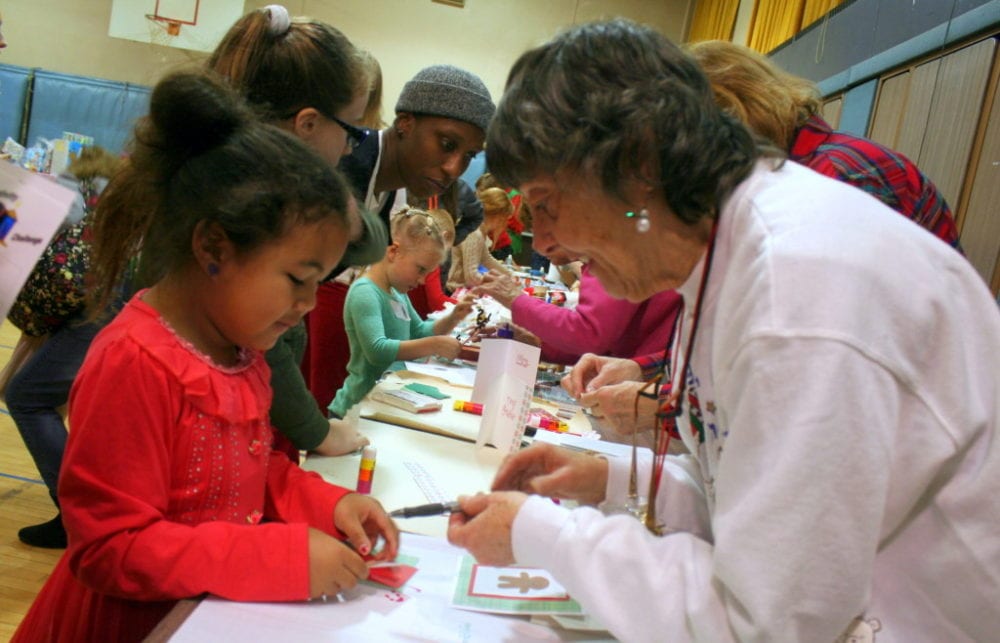 Jaden Lee, Oneonta, gets help with making a Christmas card from Pat Murphy, Oneonta, at the 2nd annual Angel Tree Party at St. Mary's this afternoon. The event, hosted by Jail Ministries of Otsego County, provided an afternoon of activities and food for children which included card making, face painting, cookie decorating, making center pieces and other Holiday crafts. There was even a shop where kids could pick out gifts free of charge to send to their incarcerated parents. At the end of the party, each child goes home with several wrapped presents for themselves to open on Christmas day. (Ian Austin/AllOTSEGO.com)